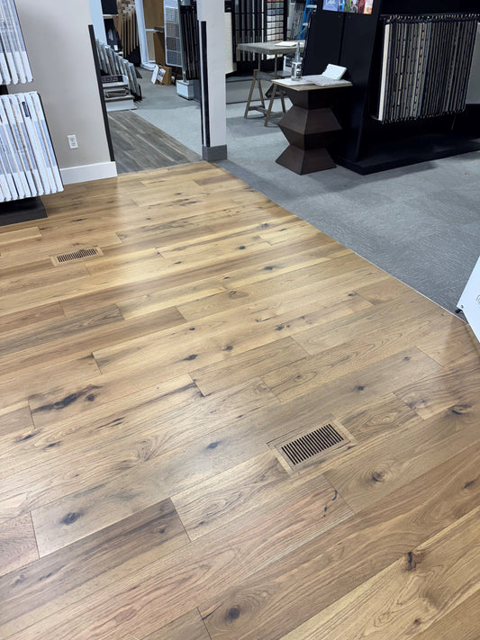2 exact match floor vents installed on the showroom floor of a local flooring dealer.