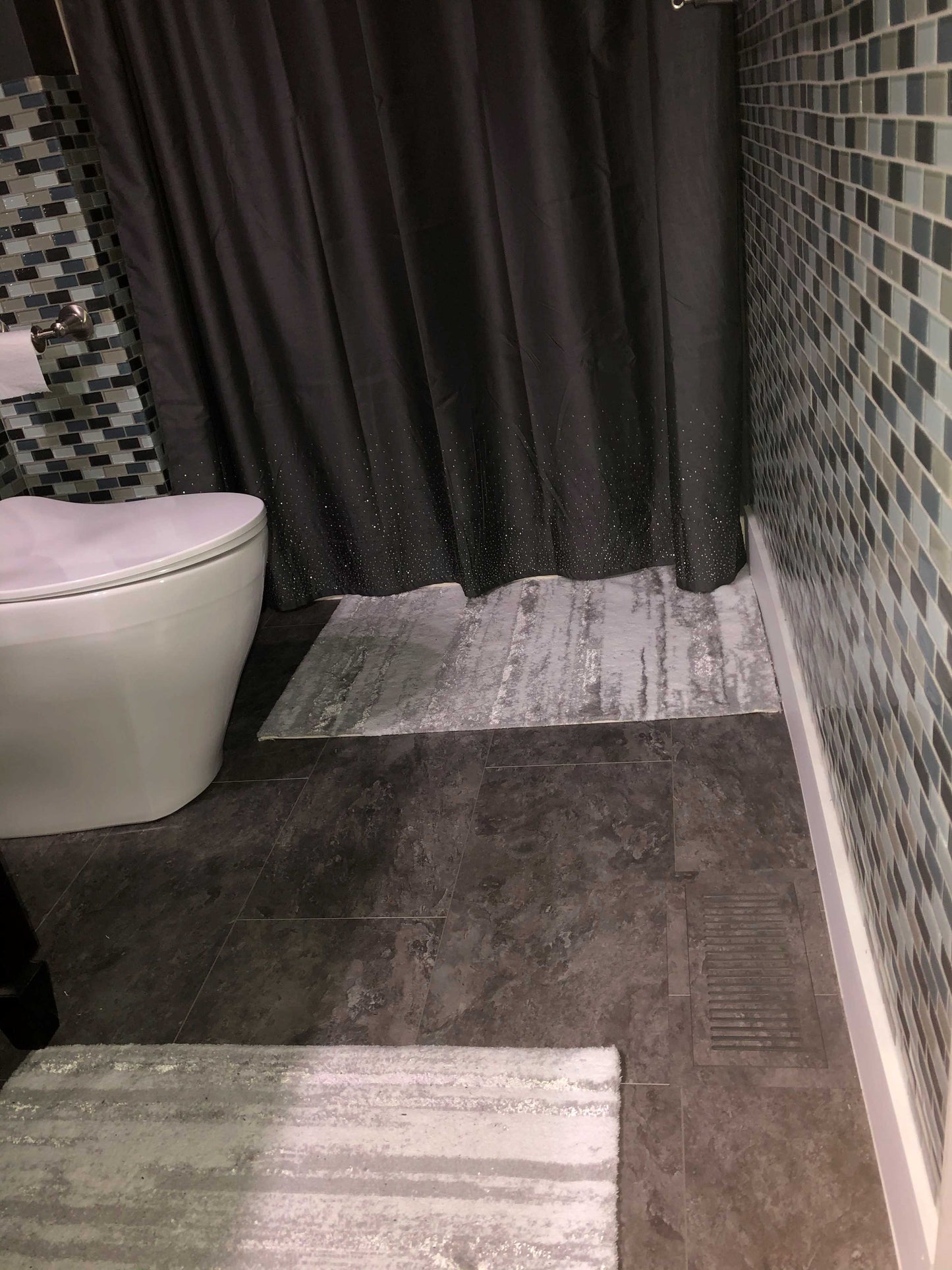 Custom LVP floor vent installed in a bathroom, seamlessly matching the luxury vinyl plank flooring for a clean, modern look while ensuring efficient airflow.