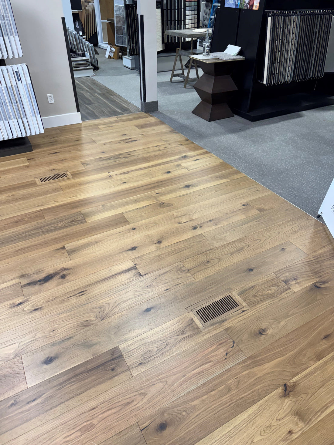 2 exact match floor vents installed on the showroom floor of a local flooring dealer.