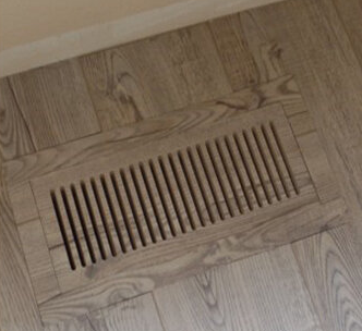 New floor-matching vent cover replacing a damaged vent