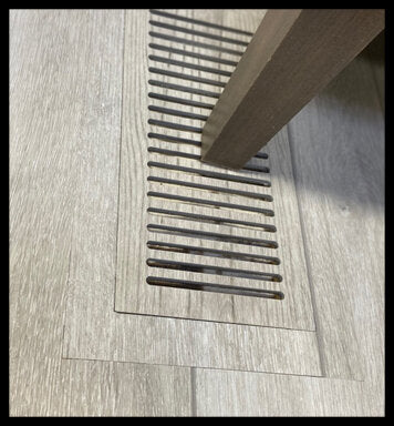Solid floor-matching vent cover made from real flooring with a sturdy frame