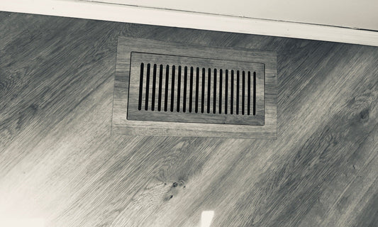 Vents.com flush vent in a gray wood-look floor