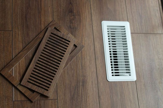 Vents.com matching vinyl plank vent next to a standard metal register