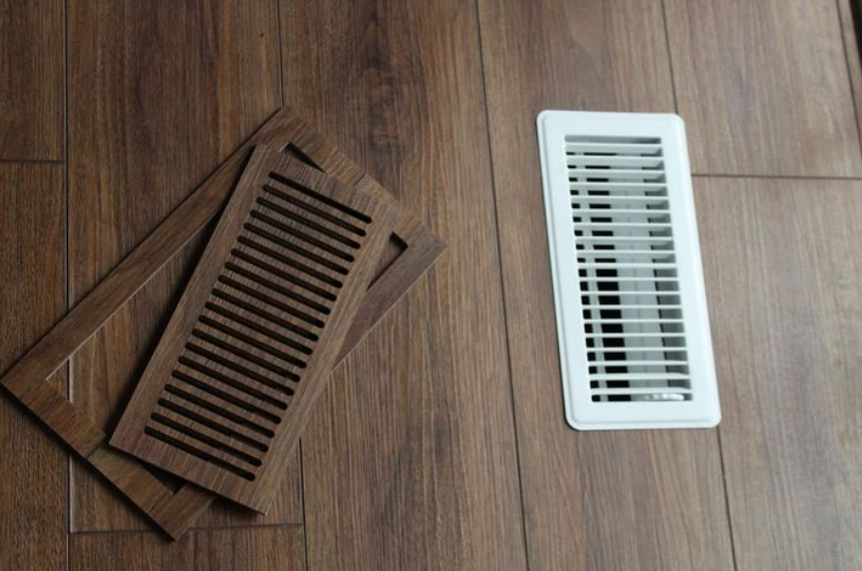 Flush custom floor vents made from luxury vinyl plank, shown matching the surrounding LVP flooring
